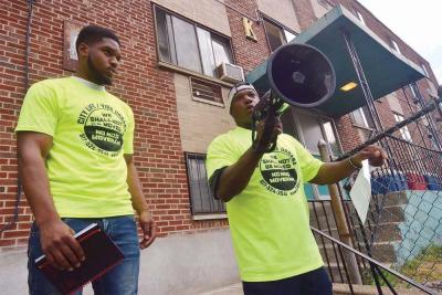 Steven Julien-Stewart, left, and Anthony Dabney, right, who lives in an apartment at 200 Hancock St. with his 11 year-old son, spoke out at a rally last Saturday. Tenants are upset that the owner has raised rents without making improvements to the building, which they claim is in poor condition. Chris Lovett photo